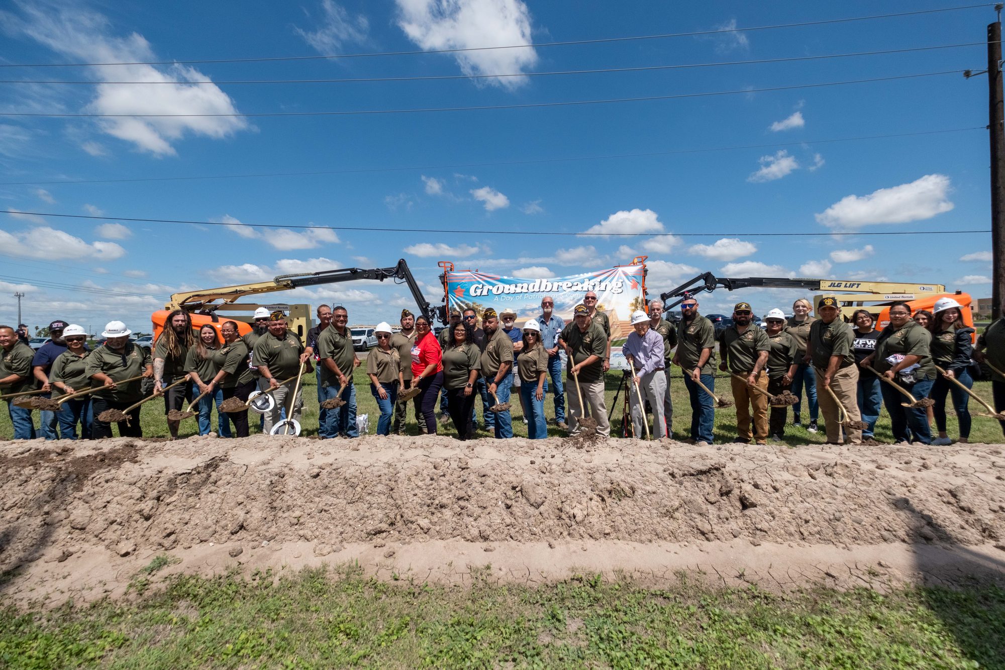 Veterans, officials, and community members lined up with shovels at the VFW Post 2410 groundbreaking in Harlingen, Texas
