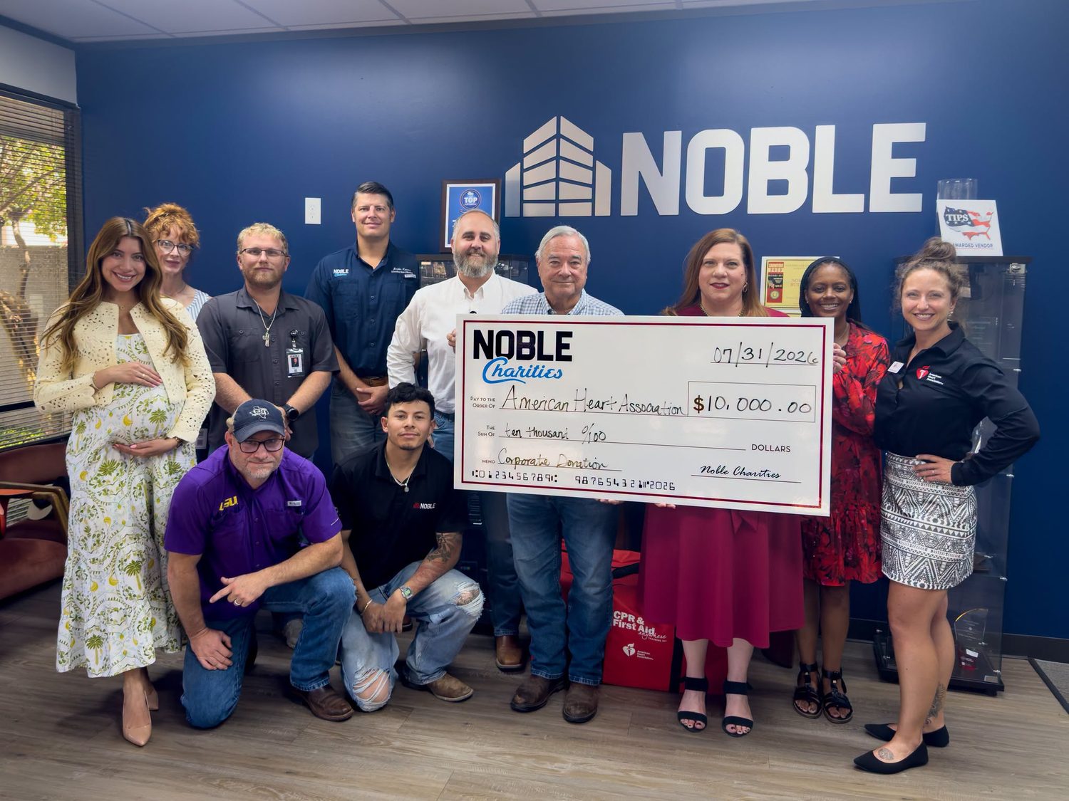 Noble Charities staff presenting a $10,000 corporate donation check to American Heart Association representatives