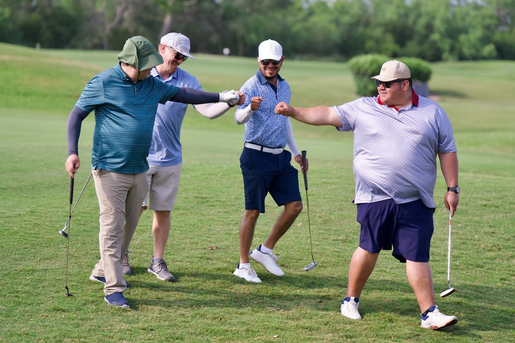 Golfers sharing a moment on the course at the Noble Charities Golf Tournament