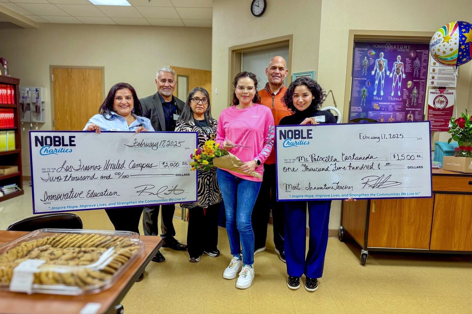 Priscilla Casta&ntilde;eda receives the Most Innovative Teacher Award alongside Noble Charities representatives holding presentation checks